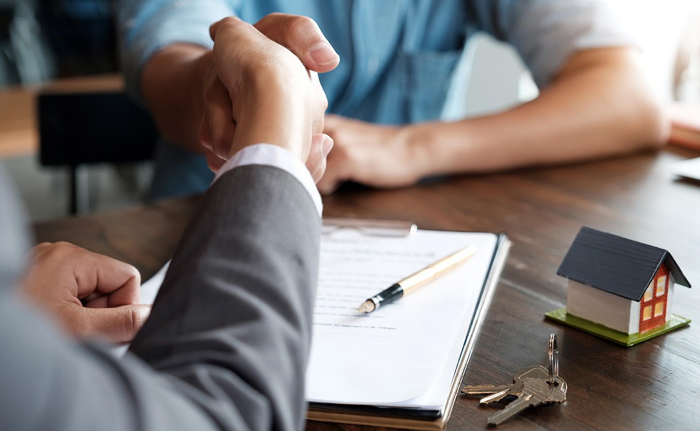 Guy Shaking A Hand. Applying for a mortgage.