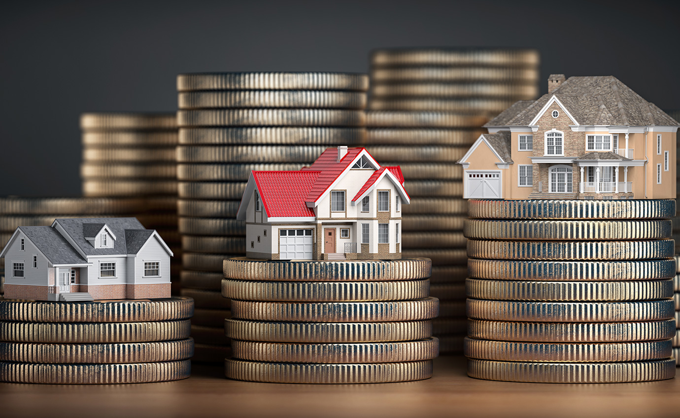 tiny houses on top of stacks of coins