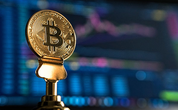 Cryptocurrency in front of stock screen