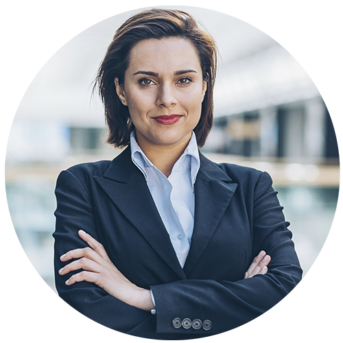 Businesswoman in navy suite jacket smirking with arms crossed.