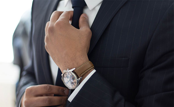 Image of man adjusting black tie