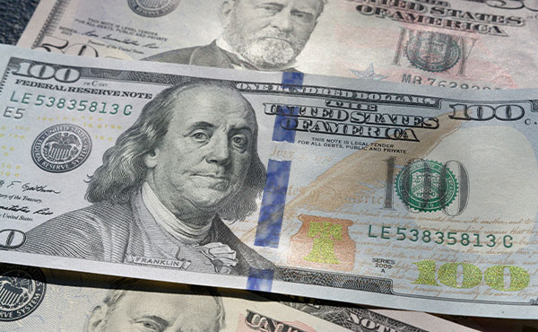 American $100 bill on top of two American $50 bills