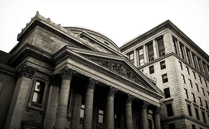 Grey-scale image of bank next to brick building